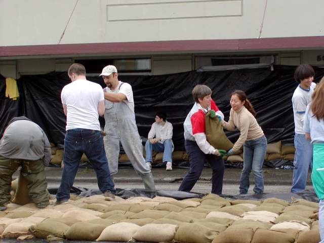 Volunteers helping to build a sandbag wall in downtown mount vernon